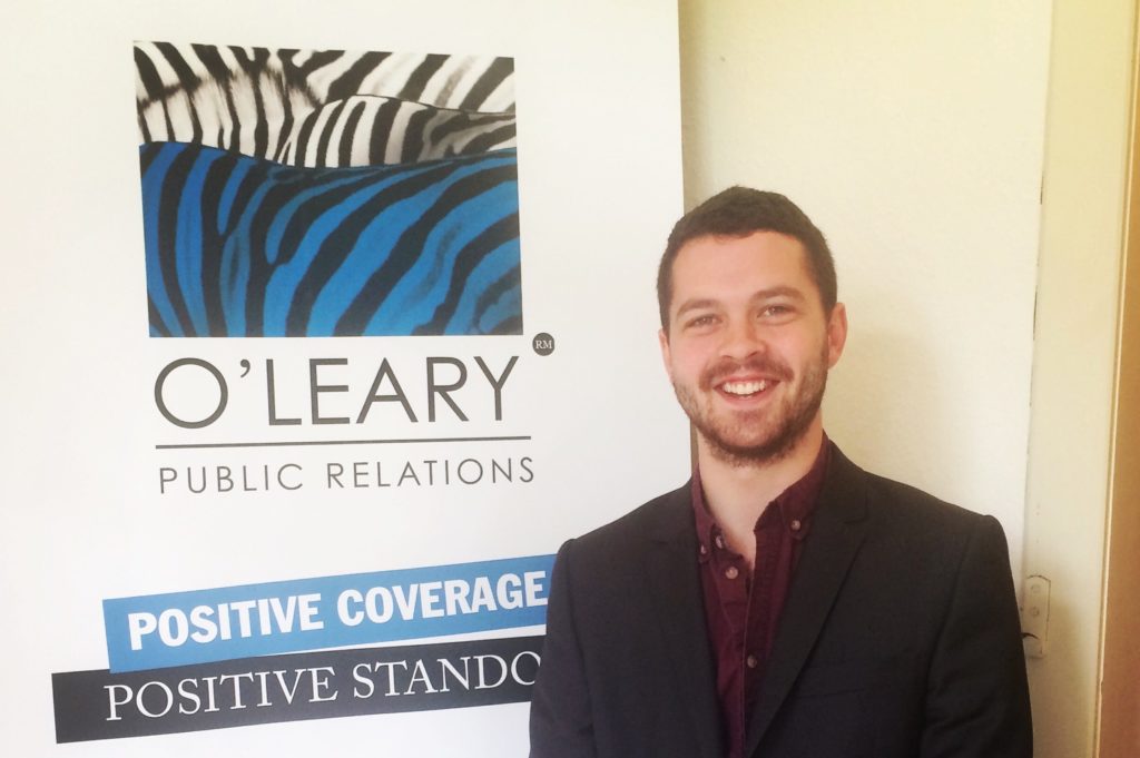 ed hipwell standing beside oleary pr poster