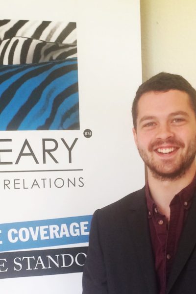 ed hipwell standing beside oleary pr poster