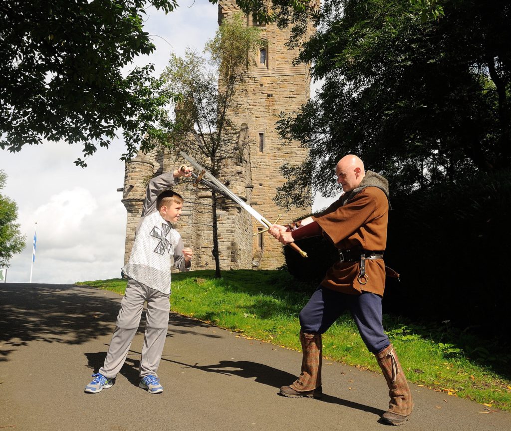 William Wallace monument with staged fight in front of it